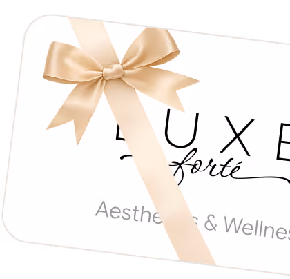 Gift card with a beige satin ribbon bow and partial text 'LUXE forté Aesthetic & Wellness'.